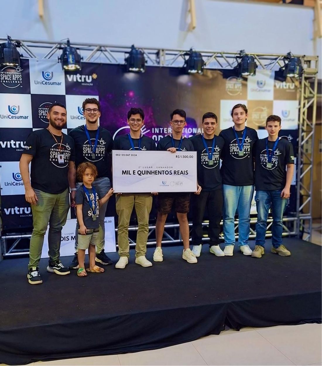 Equipe Socio Tech no palco com o cheque de 2º lugar do NASA Space Apps 2024